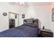 Bedroom featuring dark wood floors, red LED accent lighting, and a built-in headboard with shelving at 3805 Sorrowing Sparrow Ct, North Las Vegas, NV 89032