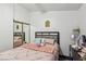 Neutral bedroom with a mirrored dresser and gray upholstered headboard at 3805 Sorrowing Sparrow Ct, North Las Vegas, NV 89032