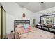 Neutral bedroom with a mirrored dresser and gray upholstered headboard at 3805 Sorrowing Sparrow Ct, North Las Vegas, NV 89032