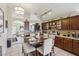 Eat-in kitchen featuring a dining table, granite countertops, and dark wood cabinetry at 3805 Sorrowing Sparrow Ct, North Las Vegas, NV 89032