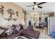 Comfortable living room featuring a sectional sofa, ceiling fan, and adjacent dining area at 3805 Sorrowing Sparrow Ct, North Las Vegas, NV 89032