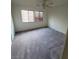 Bedroom with ceiling fan, two windows, and neutral carpet at 4039 Meadow Foxtail Dr, Las Vegas, NV 89122