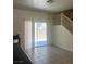 Dining area with sliding glass doors leading to the backyard and stairs to the second floor at 4039 Meadow Foxtail Dr, Las Vegas, NV 89122