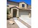 Two-story home with a two car garage and a desert landscaped yard at 4039 Meadow Foxtail Dr, Las Vegas, NV 89122