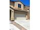 A two-story home with a two-car garage and low maintenance landscaping at 4039 Meadow Foxtail Dr, Las Vegas, NV 89122