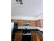 Kitchen featuring stainless steel appliances, wooden cabinetry, and dark countertops at 4039 Meadow Foxtail Dr, Las Vegas, NV 89122