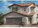 Charming two-story home featuring a terracotta tile roof, neutral stucco, and an attached two-car garage at 4218 Yucca Brevi Ave, Las Vegas, NV 89139