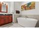 Bright bathroom with a soaking tub, cherry-wood cabinets, and an elegant vanity at 4525 Dean Martin Dr # 1500, Las Vegas, NV 89103