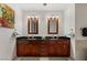 Modern bathroom featuring double sinks, stylish mirrors, and cherry-wood cabinets at 4525 Dean Martin Dr # 1500, Las Vegas, NV 89103