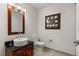 Stylish powder room with a vessel sink, cherry-wood vanity, and neutral paint at 4525 Dean Martin Dr # 1500, Las Vegas, NV 89103