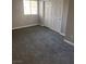 This bedroom features a double-door closet, a window, and gray carpeting at 4965 Indian River Dr # 101, Las Vegas, NV 89103