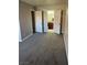 Bedroom view showing two open doorways and gray carpeting at 4965 Indian River Dr # 101, Las Vegas, NV 89103