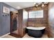 Chic bathroom featuring a glass-enclosed shower, freestanding tub, and stylish fixtures at 5049 Forest Oaks Dr, Las Vegas, NV 89149