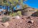 Stone sign marking the entrance to the Painted Desert community with desert landscaping and mature trees at 5049 Forest Oaks Dr, Las Vegas, NV 89149