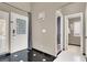 Inviting entryway with a decorative glass front door and black-and-white tile flooring at 5049 Forest Oaks Dr, Las Vegas, NV 89149