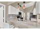 Well-lit kitchen with granite countertops, stainless steel appliances, and a decorative tiled backsplash at 5049 Forest Oaks Dr, Las Vegas, NV 89149