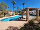 Community pool with a shaded pergola, ideal for enjoying sunny days in a desert oasis at 5049 Forest Oaks Dr, Las Vegas, NV 89149