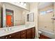 A bright bathroom with dual sinks, a large mirror, tub, and shower at 505 Los Dolces St, Las Vegas, NV 89138