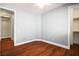 An empty bedroom with wood floors, base molding, and multiple doorways at 505 Los Dolces St, Las Vegas, NV 89138