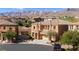 Charming two-story home featuring desert landscaping and majestic mountain views at 505 Los Dolces St, Las Vegas, NV 89138