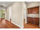 Hallway with wood floors and built-in cabinets next to an arched entry to the bathroom at 505 Los Dolces St, Las Vegas, NV 89138