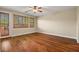 Bright living room featuring wood floors, ceiling fan, and window with wooden shutters at 505 Los Dolces St, Las Vegas, NV 89138