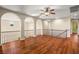 Upstairs living room with arched openings, wood floors, and a ceiling fan at 505 Los Dolces St, Las Vegas, NV 89138