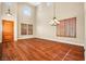 Elegant living room with high ceilings, hardwood floors, and large windows with shutters at 505 Los Dolces St, Las Vegas, NV 89138