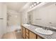 Bathroom featuring double sinks, granite countertops, and a shower-tub combination at 5055 W Hacienda Ave # 1116, Las Vegas, NV 89118