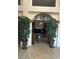 Grand foyer entrance featuring travertine floors, archway, and elegant decorative plants at 5055 W Hacienda Ave # 1116, Las Vegas, NV 89118