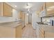 Bright kitchen featuring white appliances, light wood cabinets, and ample counter space for meal preparation at 510 Crumpler Pl, Henderson, NV 89052