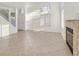 Bright living room with tiled floors, white walls, and a fireplace at 510 Crumpler Pl, Henderson, NV 89052