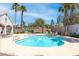 Community pool area with lounge chairs and palm trees on a sunny day with blue sky at 510 Crumpler Pl, Henderson, NV 89052