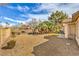 Spacious desert landscaped backyard features scattered trees and privacy fence at 5216 Las Cruces Dr, Las Vegas, NV 89130