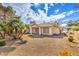 Desert landscaped backyard including patio and scattered trees at 5216 Las Cruces Dr, Las Vegas, NV 89130