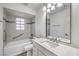 Bright bathroom featuring a shower-over-tub and modern vanity with ample lighting at 5216 Las Cruces Dr, Las Vegas, NV 89130