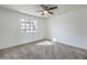 Bedroom with carpet flooring, ceiling fan, and a window for natural light at 5216 Las Cruces Dr, Las Vegas, NV 89130