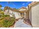 Close up of the entryway of a home with an inviting pathway and beautiful, mature landscaping at 5216 Las Cruces Dr, Las Vegas, NV 89130