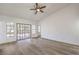 Living room with hardwood-style floors, a sliding glass door and large windows at 5216 Las Cruces Dr, Las Vegas, NV 89130