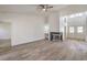 An open-concept living room featuring a fireplace, wood-style flooring, and a vaulted ceiling at 5216 Las Cruces Dr, Las Vegas, NV 89130