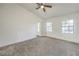 Bright main bedroom featuring carpet floors, ceiling fan, and a neutral color palette at 5216 Las Cruces Dr, Las Vegas, NV 89130