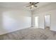 Spacious main bedroom featuring carpet floors, ceiling fan and ensuite bathroom at 5216 Las Cruces Dr, Las Vegas, NV 89130