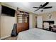 This bedroom has a ceiling fan, wood floors, a bed and a built in bookshelf at 524 Turtleback Rd # A, Mesquite, NV 89027