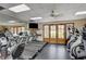 Well-equipped gym with treadmills, fitness machines, and a TV; wooden doors overlook the outside, creating an ideal workout space at 524 Turtleback Rd # A, Mesquite, NV 89027