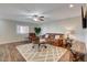 Comfortable living room features a ceiling fan, wood-look floors, a large rug, and cozy seating at 524 Turtleback Rd # A, Mesquite, NV 89027