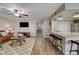 This living room has wood floors, ceiling fan and adjoins the kitchen at 524 Turtleback Rd # A, Mesquite, NV 89027