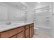 Well-lit bathroom featuring a white quartz countertop with double sinks and a bathtub-shower combo at 5398 Pico Viejo St, Las Vegas, NV 89166