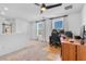 A light-filled bonus room with neutral carpet and two windows, plus a computer, desk, and chair at 5398 Pico Viejo St, Las Vegas, NV 89166