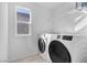 Well-lit laundry room with modern washer and dryer set, and ample shelving at 5398 Pico Viejo St, Las Vegas, NV 89166