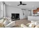 Open concept living room featuring modern ceiling fan, plank floors, neutral paint, large windows, and TV at 5398 Pico Viejo St, Las Vegas, NV 89166